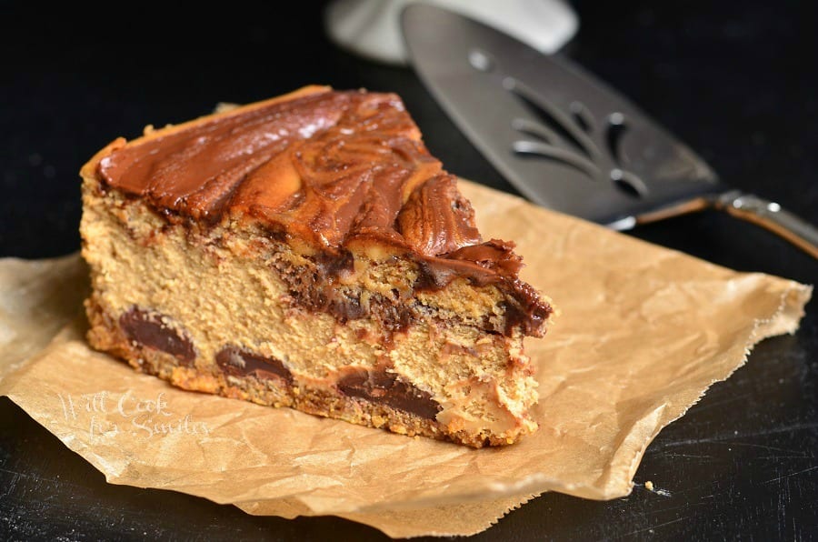 slice of Gingerbread Nutella Swirl Cheesecake on a piece of butcher paper with pie spatula at top right side 