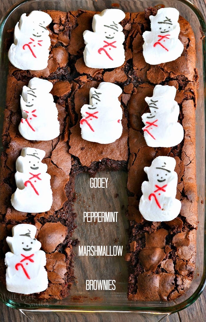 view from above of a glass baking dish filled with gooey peppermint marshmellow brownies on a wood