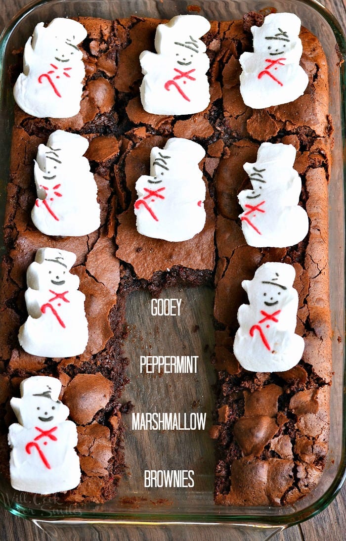 Brownies with snowman marshmallows on top in a glass baking dish 