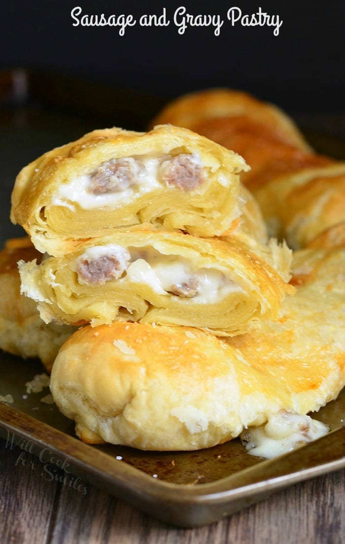 Pastry with sausage gravy and sausage in it on a baking sheet 