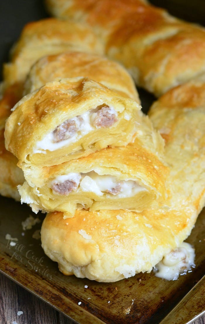 Pastry with sausage gravy and sausage in it on a baking sheet 