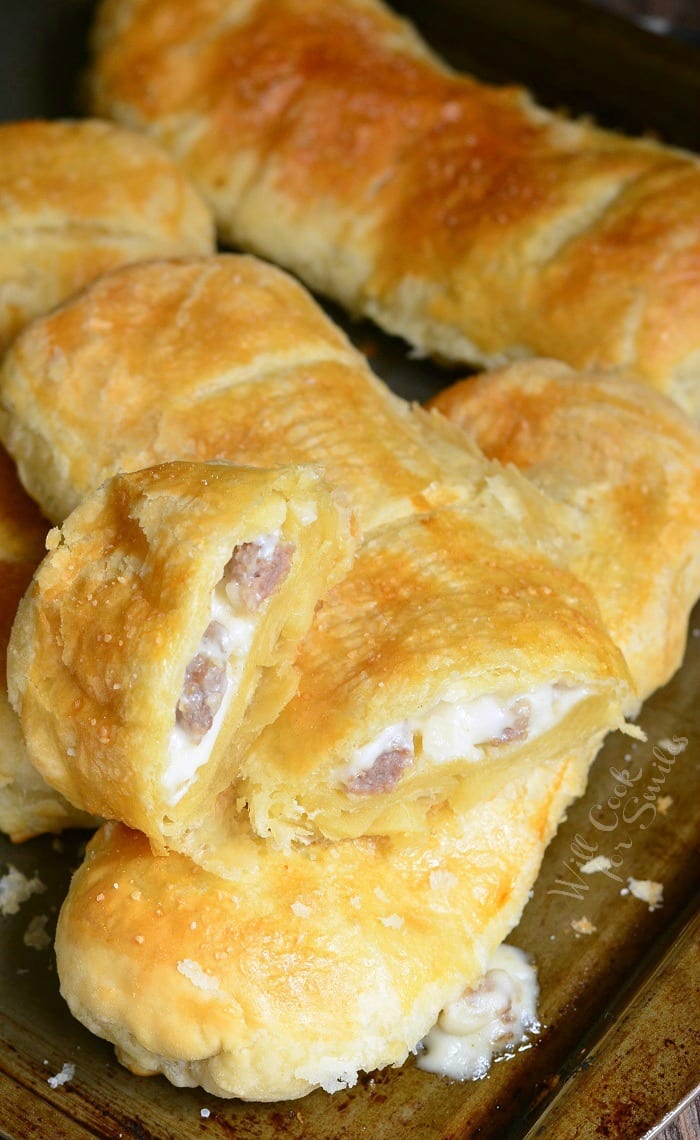 Pastry with sausage gravy and sausage in it on a baking sheet 