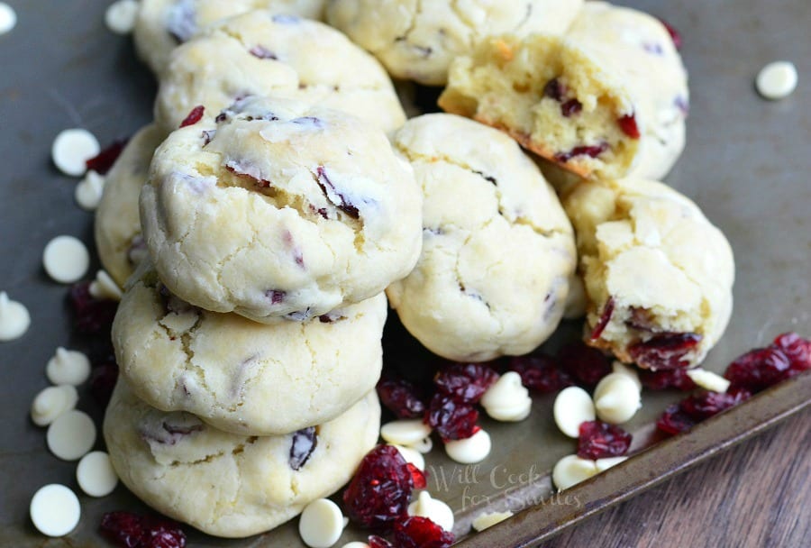 White Chocolate cookies with Cranberries staked on cookie sheet with white chocolate chips 