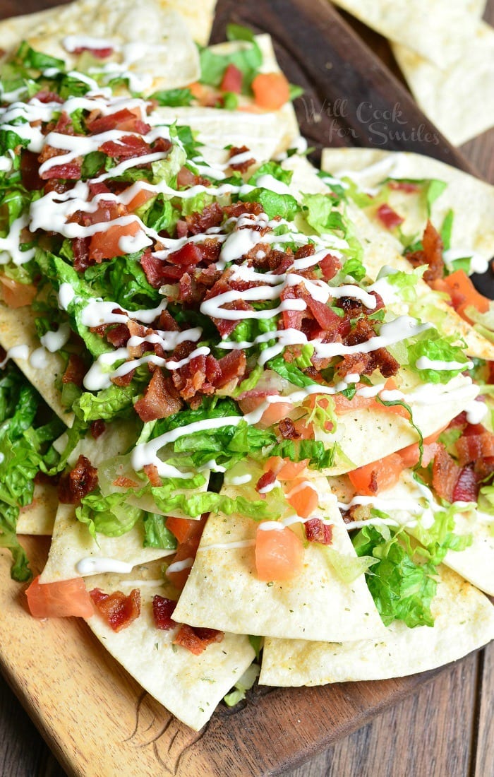 BLT Nachos with Homemade Baked Cool Ranch Tortilla Chips on a cutting board 