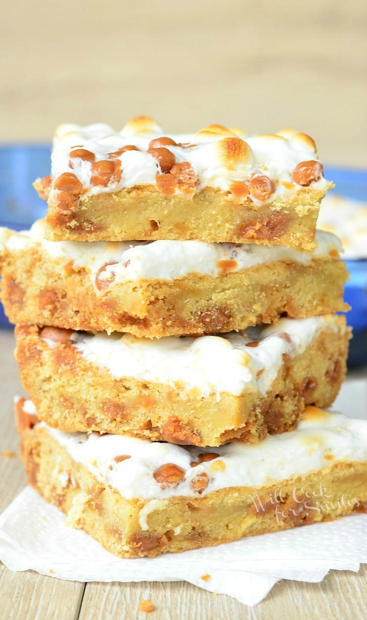 Caramel Marshmallow Cookie Bars stacked up on a table 