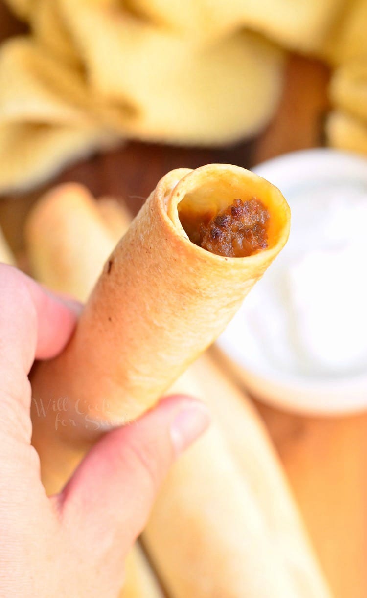 Holding a Jalapeño Sausage and Cheese Taquitos