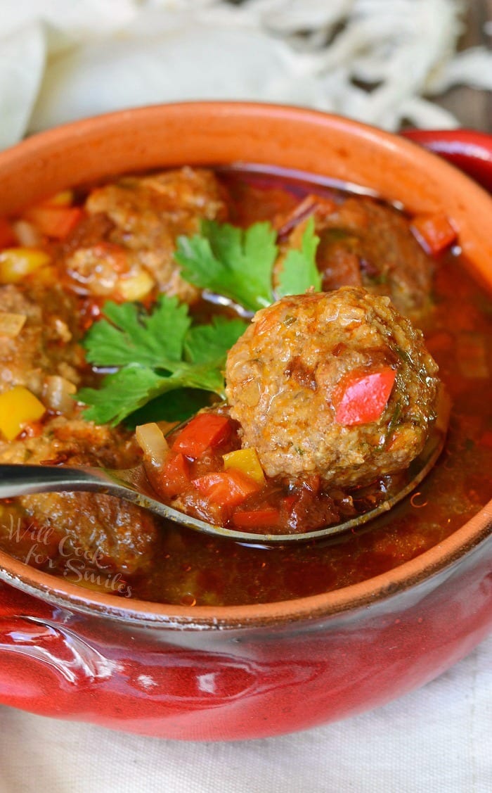 Mexican Meatballs Soup in a bowl with a spoon lifting a meatball out 