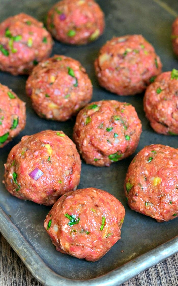 uncooked Mexican Meatballs on a baking sheet 