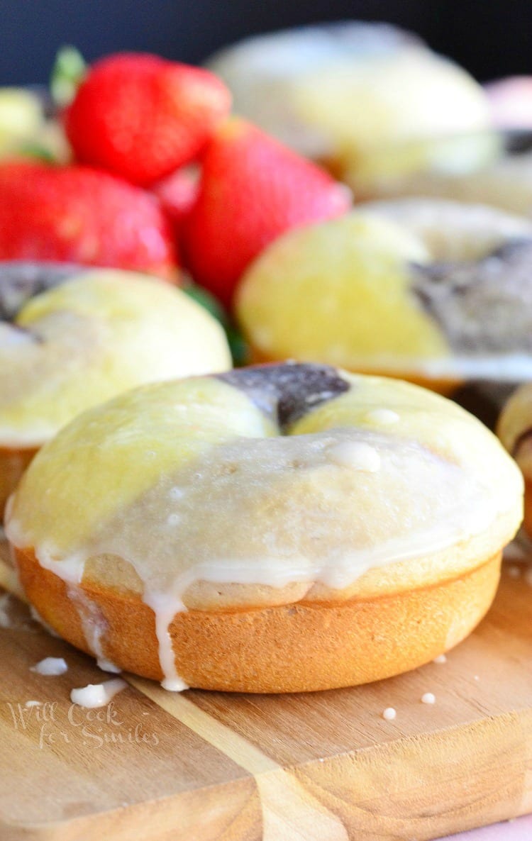 Neapolitan Doughnuts - Soft, moist, cake-like baked doughnuts inspired by the Neapolitan ice cream and made with three layers of different flavor in one. These doughnuts have chocolate, vanilla and strawberry flavors in one doughnut and dipped in glaze as an extra sweet touch.