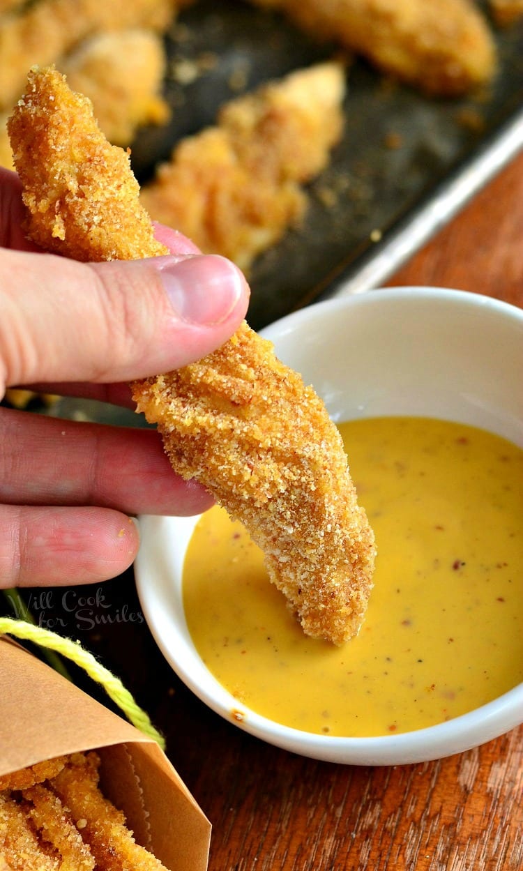 Chicken Fry being dipped into bowl of honey mustard 