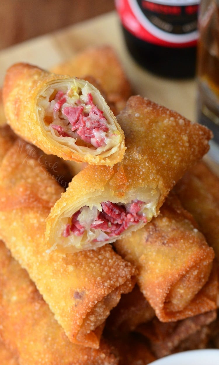 Reuben Egg Rolls stacked up and one cut in half 