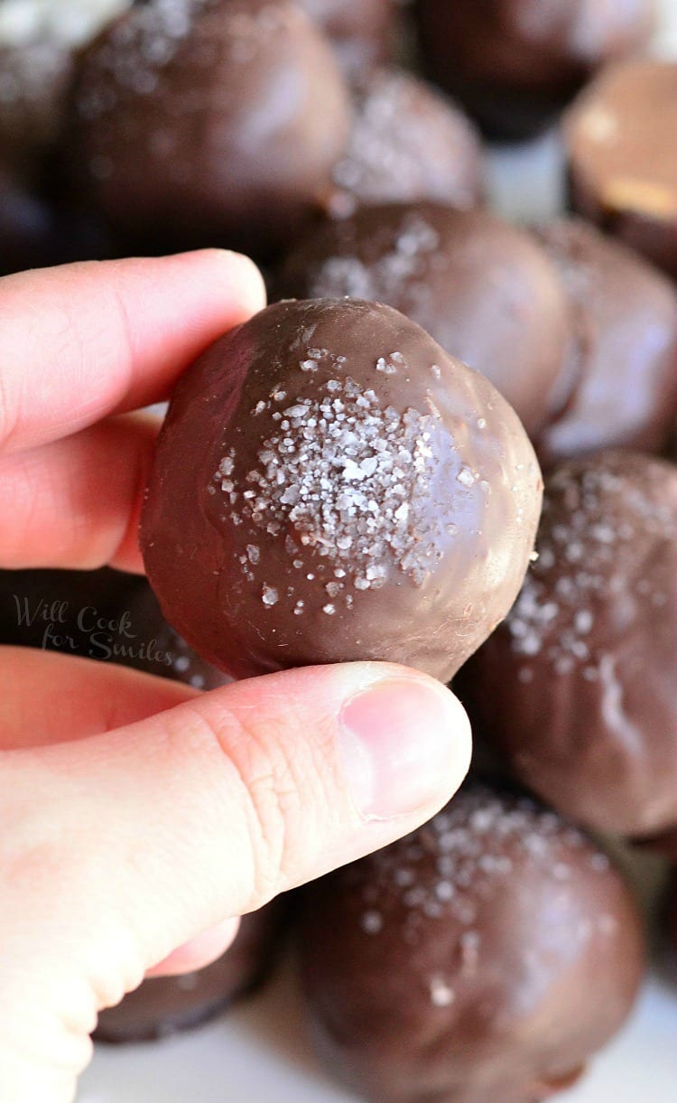 Holding a salted Almond Fudge Truffle
