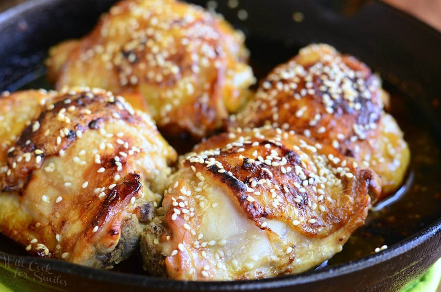 horizontal closer view of cooked chicken thighs with sesame seeds on top