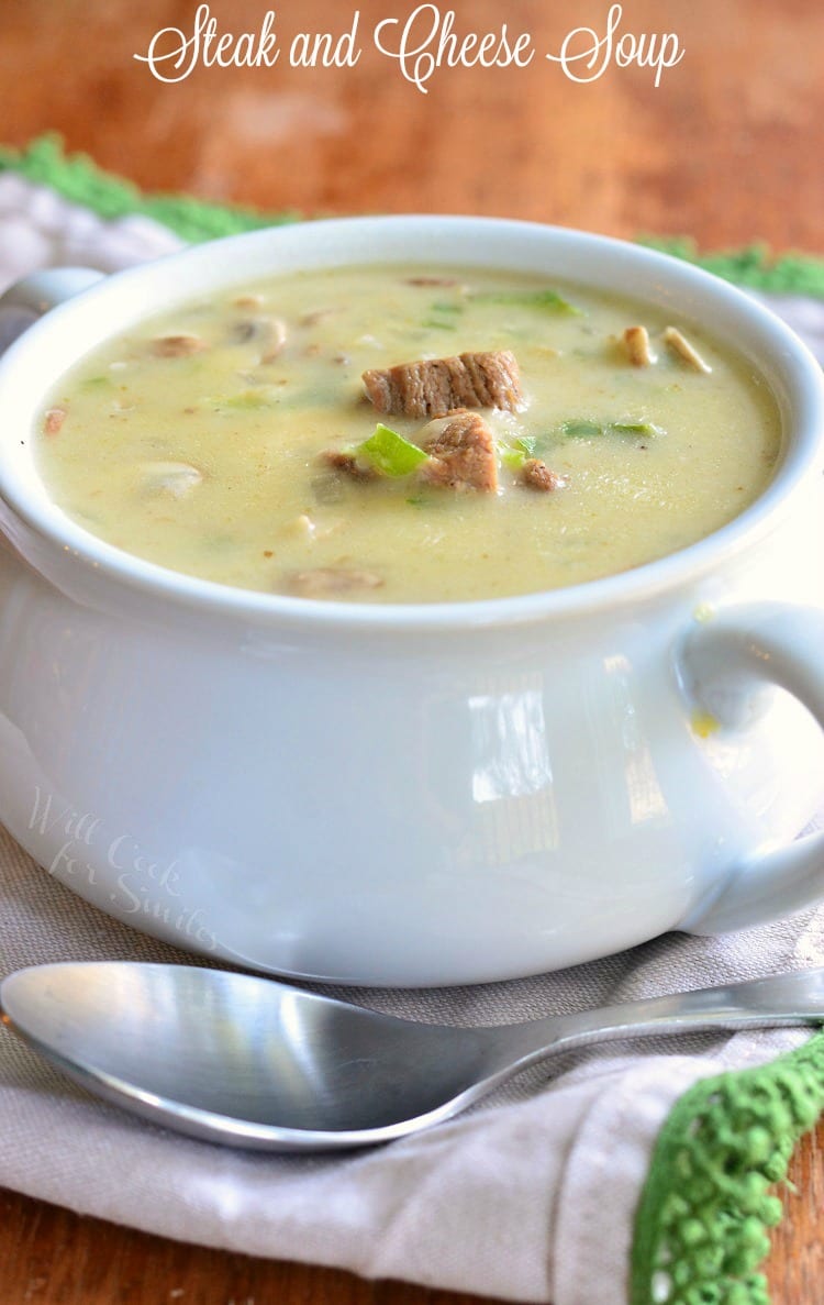 Steak and Cheese Soup in a white soup bowl with a spoon over the front