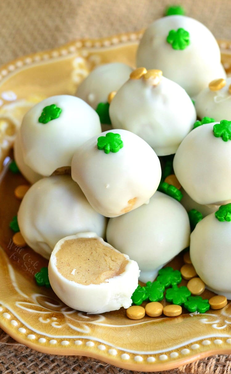 Bailey's Cookie Dough Truffles with shamrock candy on top on a yellow plate 