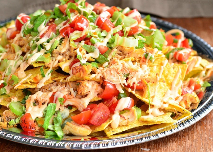 horizonal Buffalo Chicken Nachos on a metal serving plater on a table 