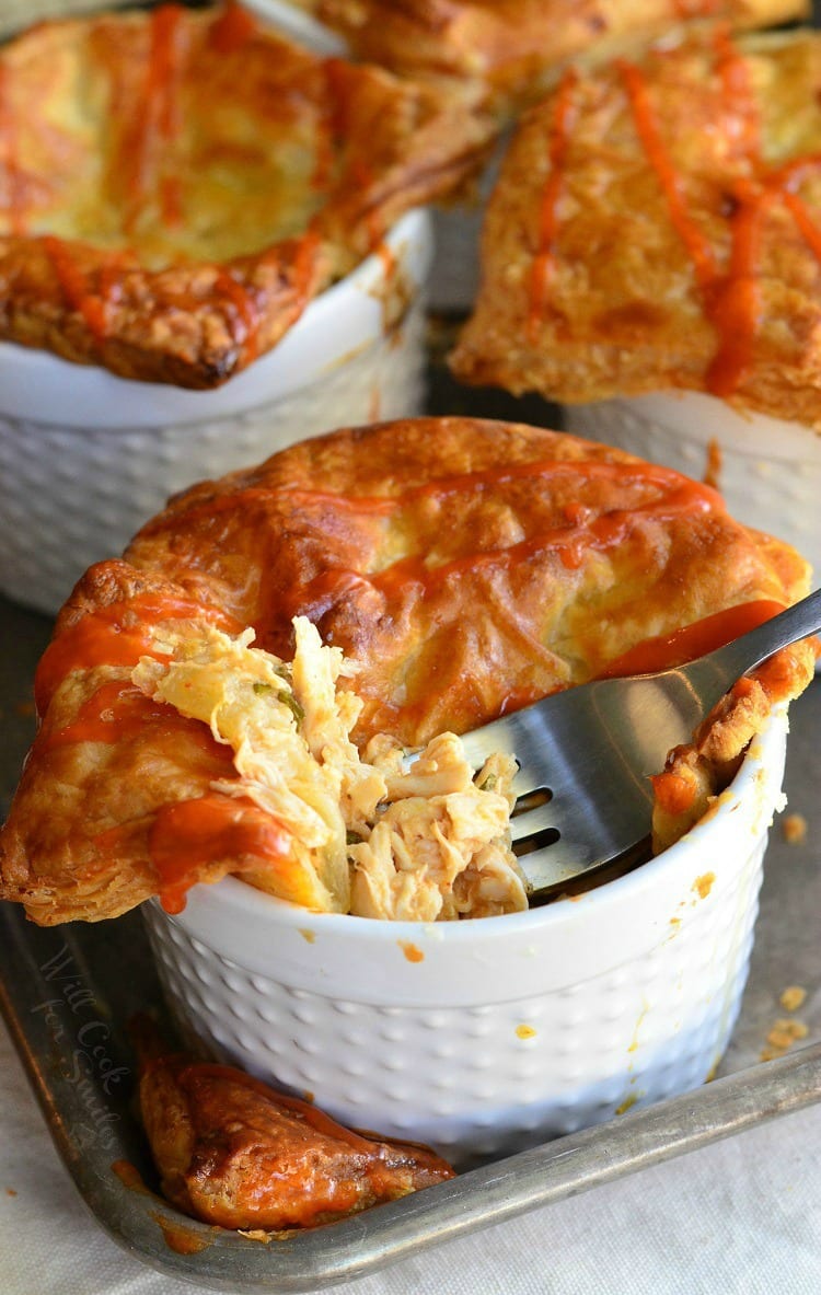 Buffalo Chicken Pot Pies in ramekin's with a fork 