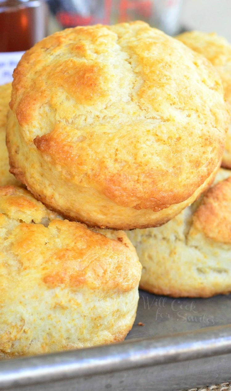 Honey Butter Biscuits stacked on a baking sheet