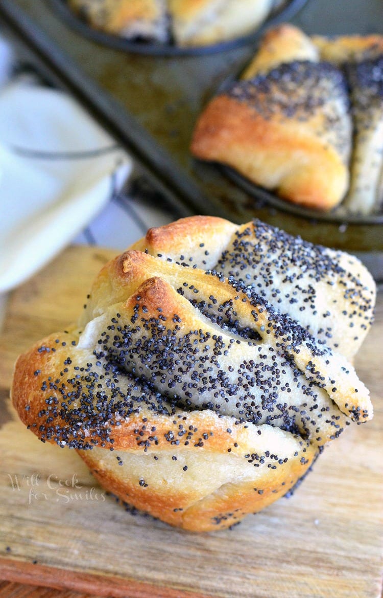 Easy Poppy Seed Pull Apart Muffin on a cutting board with a muffin tin in the background 