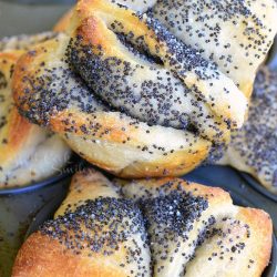 view from above of easy poppy seed pull apart muffins on a baking tray on a wooden table viewed close up