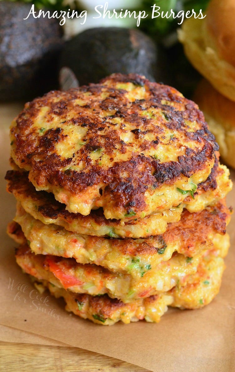 Amazing Shrimp Burgers stacked up on parchment paper 