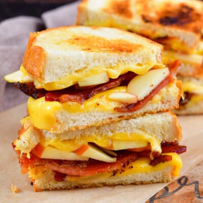 squared centered image of stacked apple bacon grilled cheese