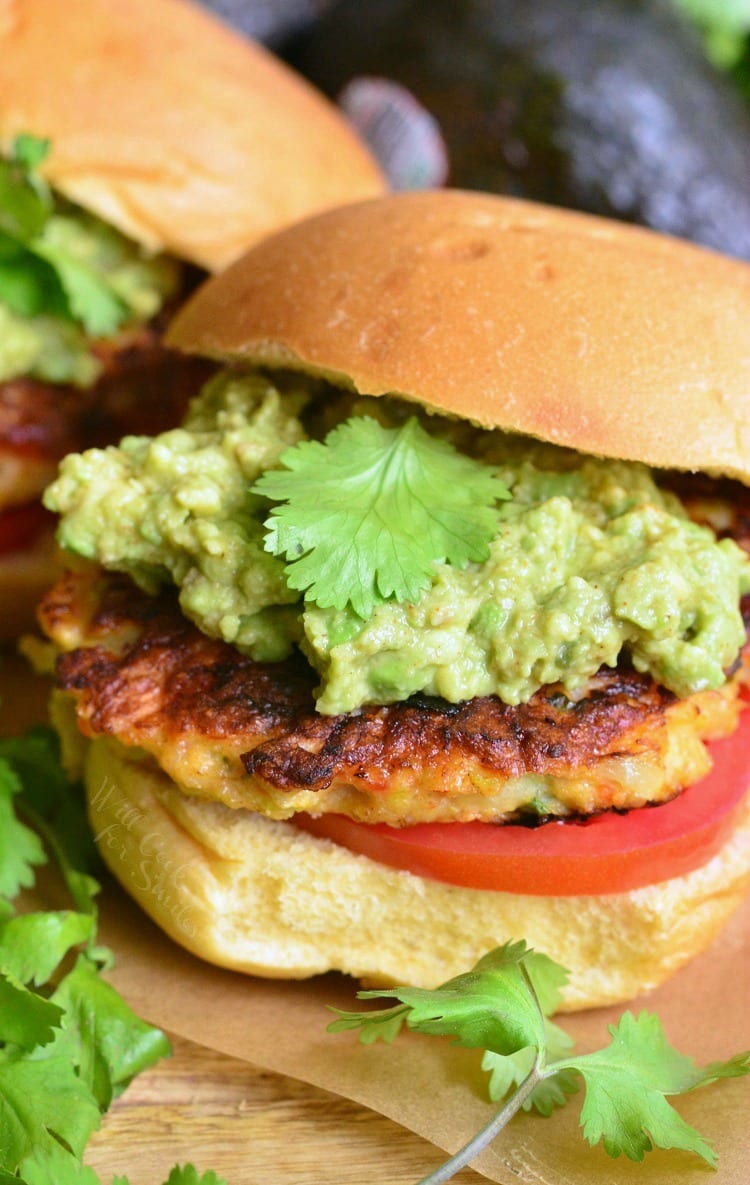 Avocado Shrimp Burgers on a bun with avocado and tomato 