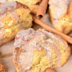 View from above of glazed cinnamon swirl scones in a baking sheet tray on a wooden table