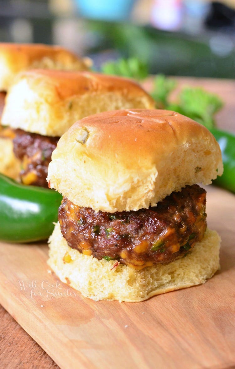 Jalapeno Cheddar Sliders on a bun on a wood table 