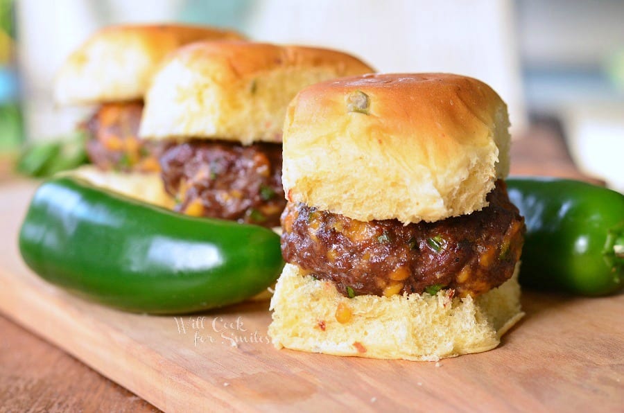 Jalapeno Cheddar Sliders on a bun on a wood table 