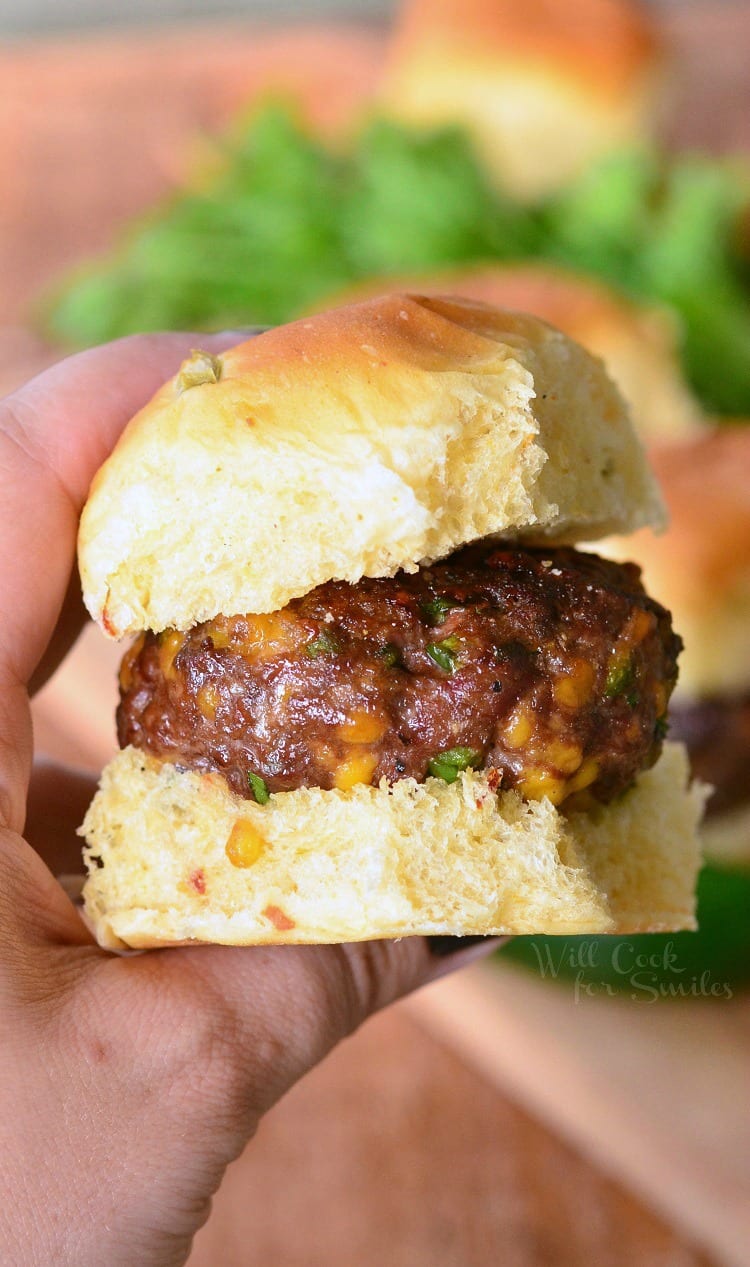 holding a Jalapeno Cheddar Slider on a bun