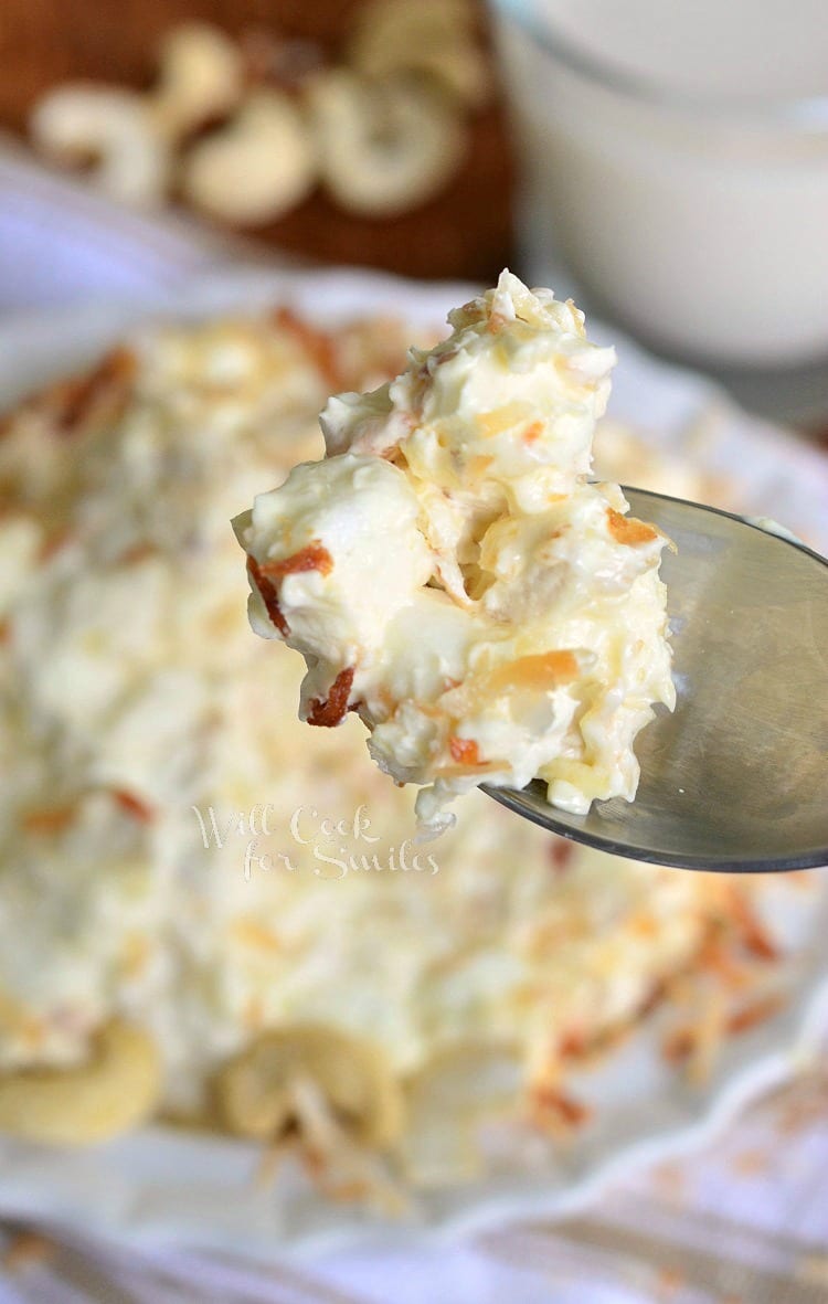 Toasted Coconut Cashew Fluff Salad in a bowl and a spoon full of fluff