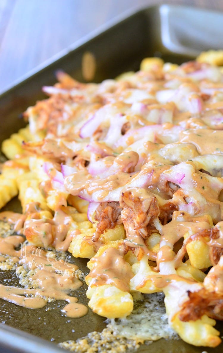 BBQ Ranch Chicken Loaded Fries with cheese over them on a baking sheet 
