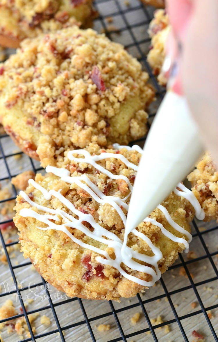 Bacon Crumb Doughnuts with icing and bacon on top on a cooling rack 