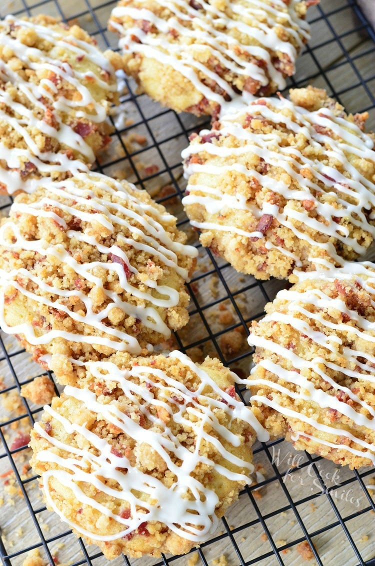 top view photo of Bacon Crumb Doughnuts with icing and bacon on top on a cooling rack 