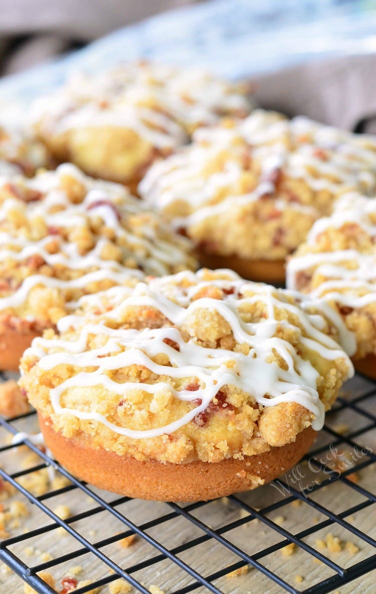 Bacon Crumb Doughnuts with icing and bacon on top on a cooling rack 