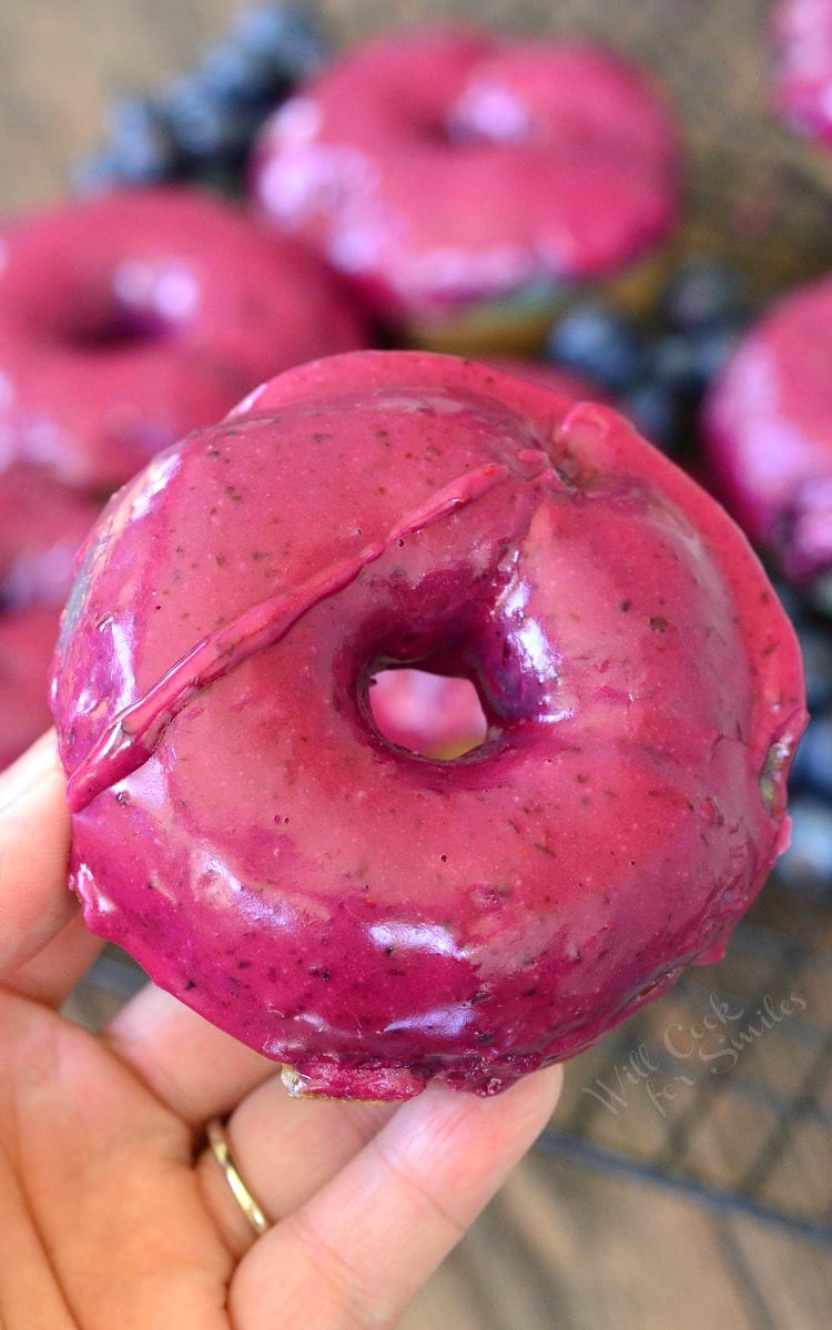 hand holding Blueberry Doughnuts with Blueberry Cream Whiskey Glaze 