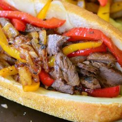 Fajita philly steak sandwich on a baking sheet tray as viewed close up and from above