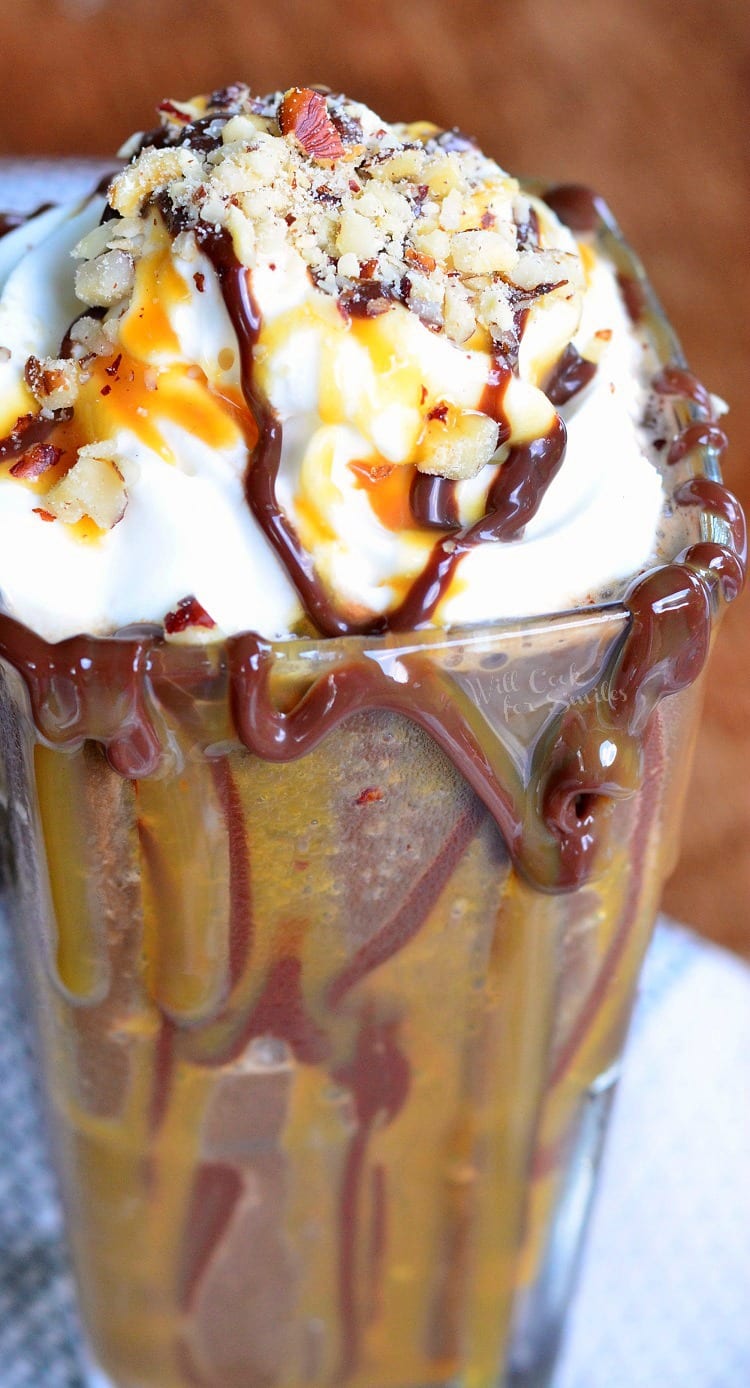 Frozen Turtle Mocha in a glass with whipped cream, chocolate, and caramel syrup on it 
