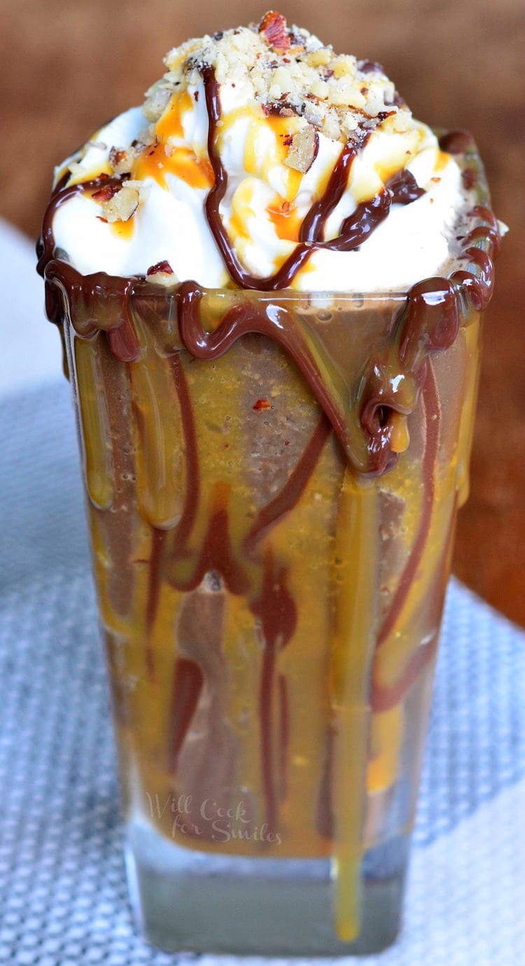 Frozen Turtle Mocha in a glass with whipped cream, chocolate, and caramel syrup on it 