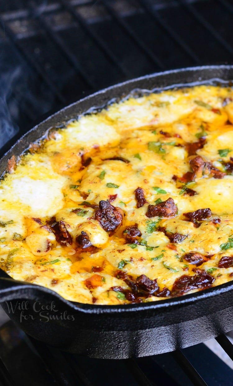 Smokey Sun-Dried Tomato and Basil Mozzarella Dip in a cast iron pan 