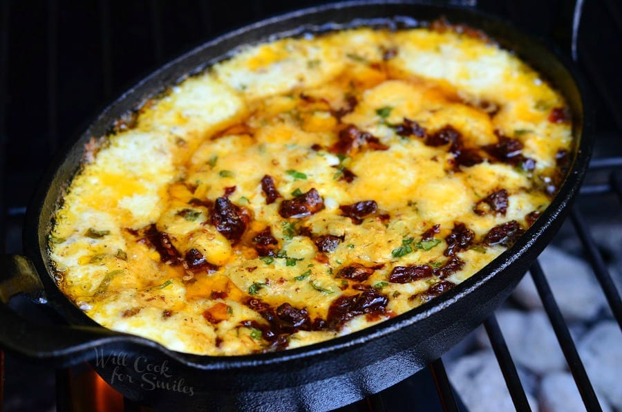 Smokey Sun-Dried Tomato and Basil Mozzarella Dip in a cast iron pan on the grill 