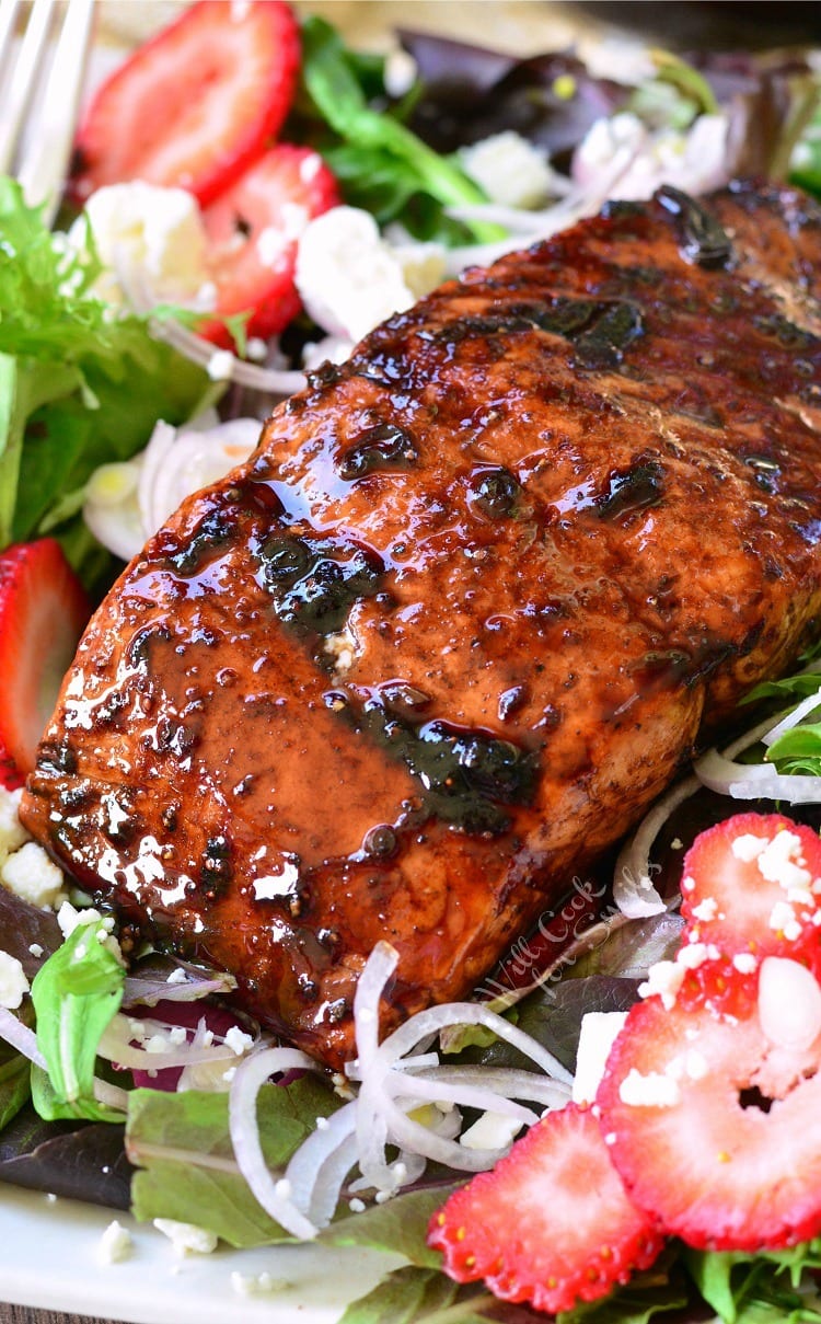 top view photo of Strawberry Balsamic salad with Glazed Salmon over the top of it 