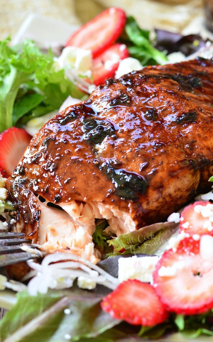 Strawberry Balsamic salad with Glazed Salmon over the top of it 