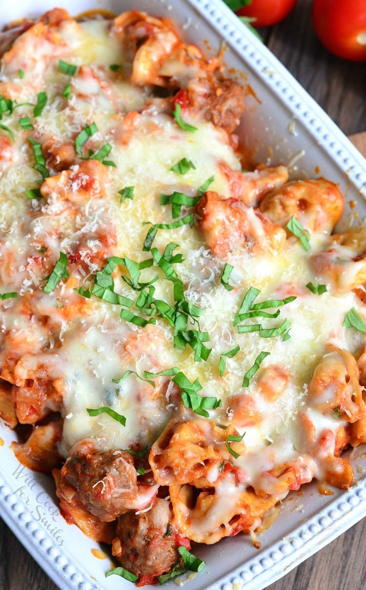 Chicken, Sausage, and pasta with cheese on top in a white casserole dish