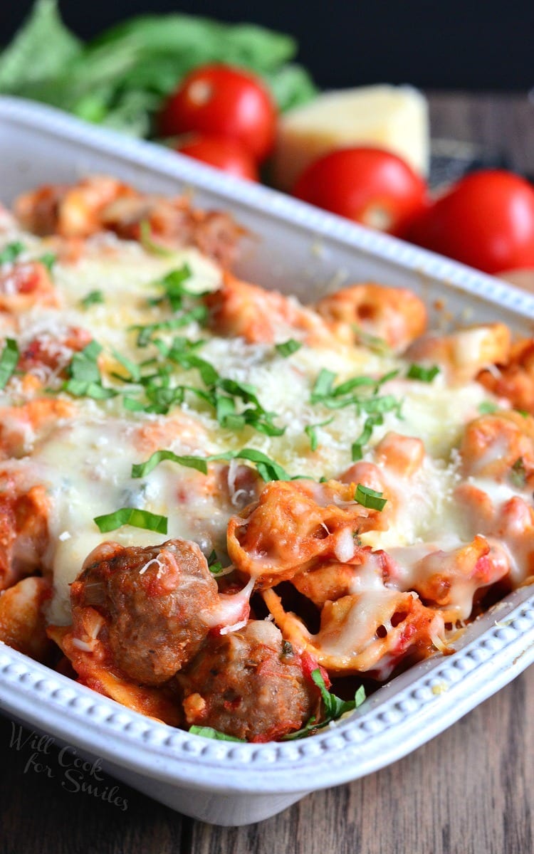 Chicken and Sausage Parmesan Tortellini Casserole in a white casserole dish 