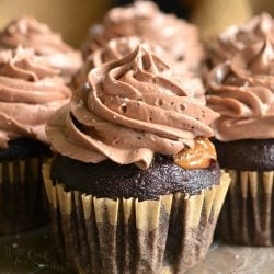 Chocolate cupcake with salted dulce de leche filling sitting on a stone counter