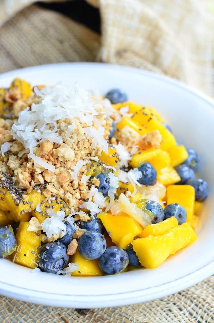 Mango, Lychee, and Blueberry with granola and coconut flakes on top in a bowl 