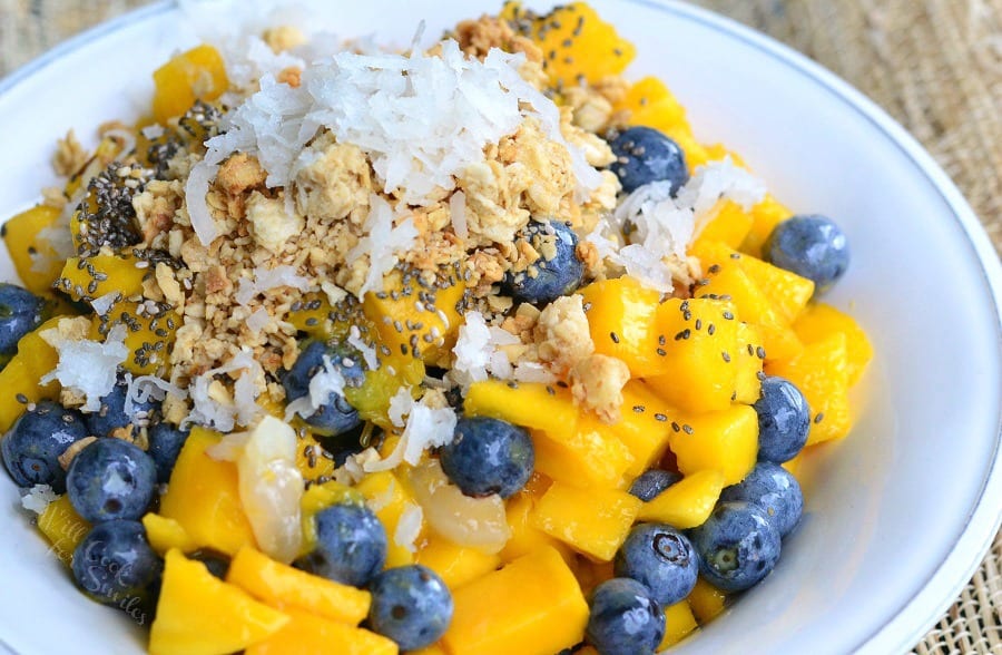 Mango, Lychee, and Blueberry with granola and coconut flakes on top in a bowl 