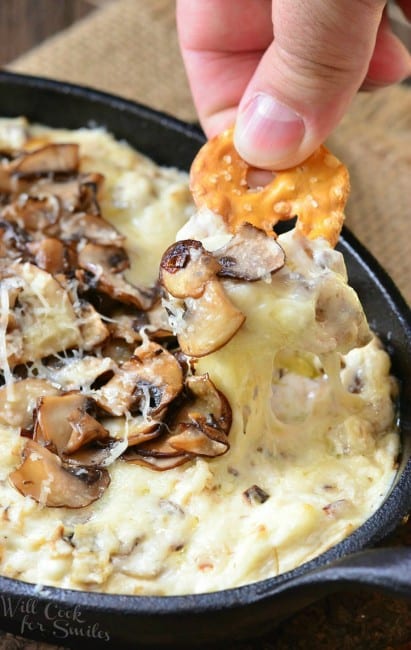 dipping pretzel chip into the mushroom cheese chip and pull out